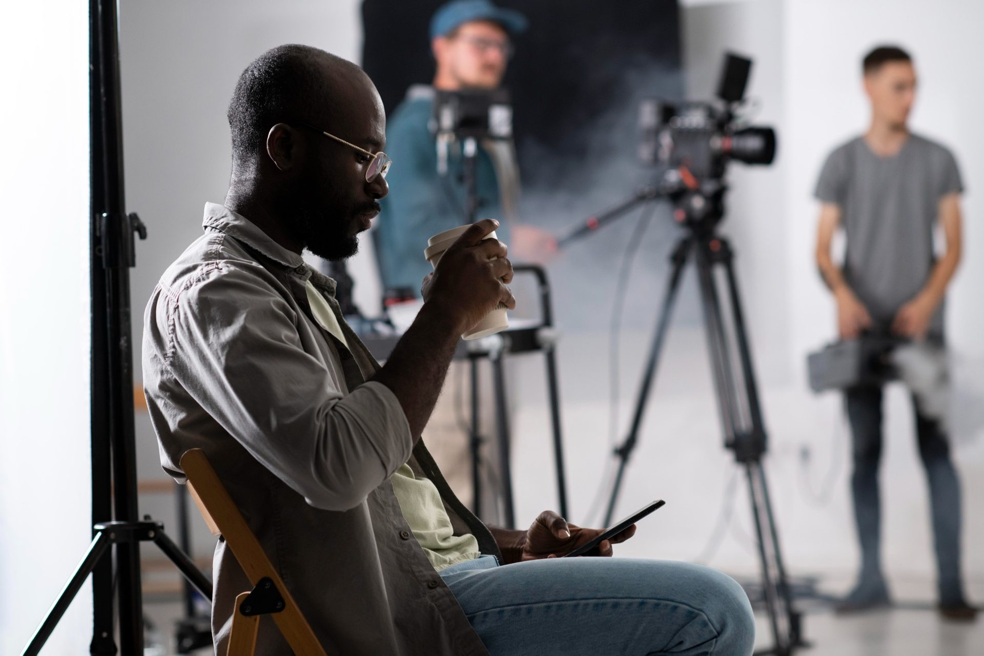 Full production crew on set — camera, lighting and sound departments working together.